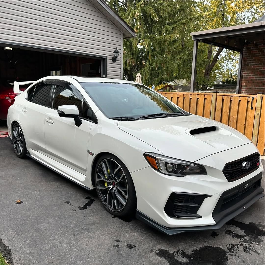 White Subaru WRX STI side profile after detail